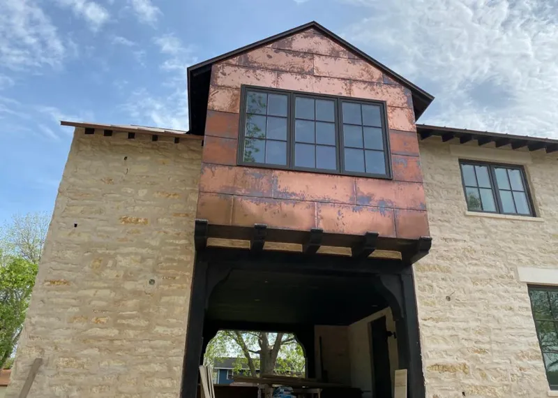 Copper metal panel facade on a stone building for Skylight Installation in Wilbraham